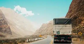 white and black truck near mountain at daytime