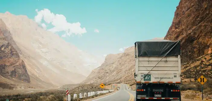 white and black truck near mountain at daytime